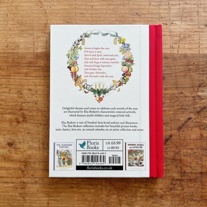 Back book cover with floral design and text on a wooden surface