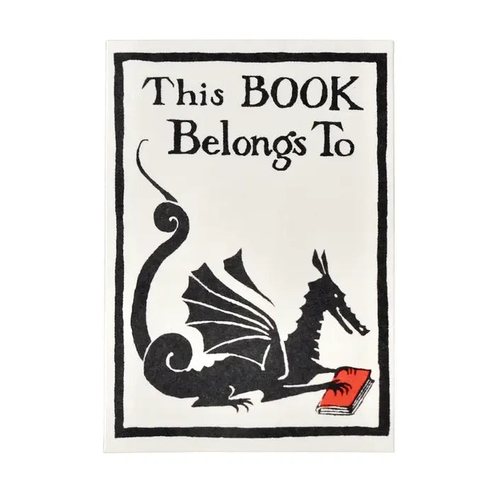 A square decorative sign or print with the text 'This BOOK Belongs To' above a black dragon illustration reading a red book, on a white background with a thin black border.