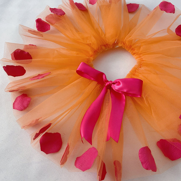 Close-up of the fuchsia ribbon bow at the waist.