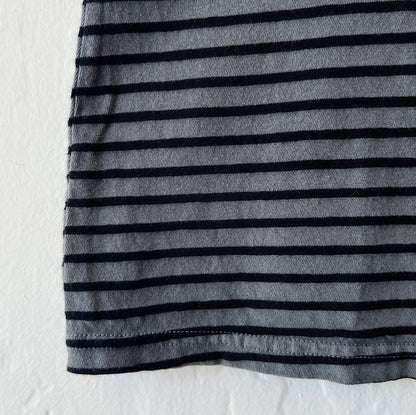 Close-up of gray t-shirt with black stripes on a white backgrond