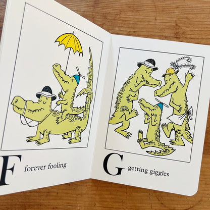 The book displayed open showing two pages with text and images of alligators