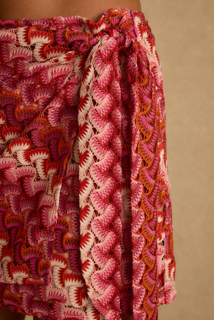 Close-up of pink and orange crochet knit texture on the Amaya wrap mini skirt.