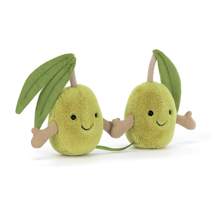 Two plush olive toys with smiling faces on a white background