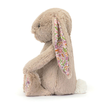 Jellycat Blossom Beige Bunny 'Petal' Original — side profile view showing the long floppy ear with white floral lining in pink, purple, and orange, beige textured fur, floral paw pad, and white cotton tail, on a white background