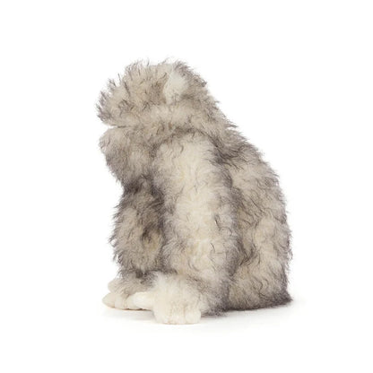 Plush toy resembling a yeti on a white background as seen from the side