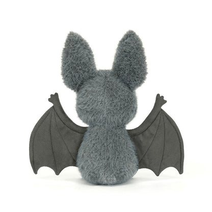 Rear view of the Jellycat Broox Bat plush toy on a white background, showing the blue-grey fluffy back, two large ears, and both dark wings spread wide