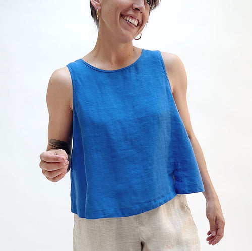 A close up shot of a person in a bright cobalt blue linen tank