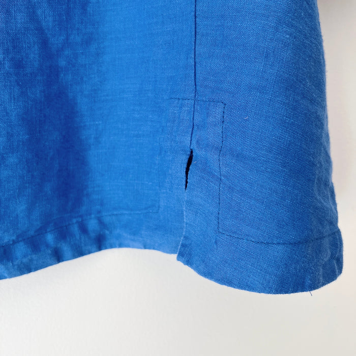 Close-up of a blue shirt with a slit on a white background