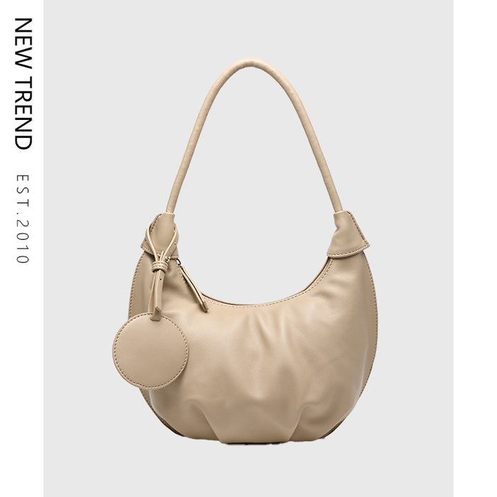Women's crescent shoulder bag with single strap, zipper closure and PU leather exterior shown from clear product detail view.