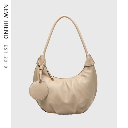 Women's crescent shoulder bag with single strap, zipper closure and PU leather exterior shown from clear product detail view.