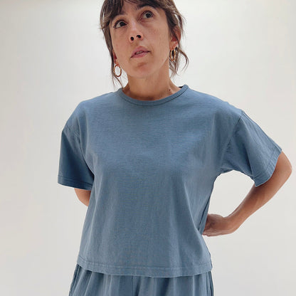 Three-quarter front view of model wearing Pacific Cotton vitznau crop crew tee, showing heavyweight cotton texture, boxy silhouette, and cropped length