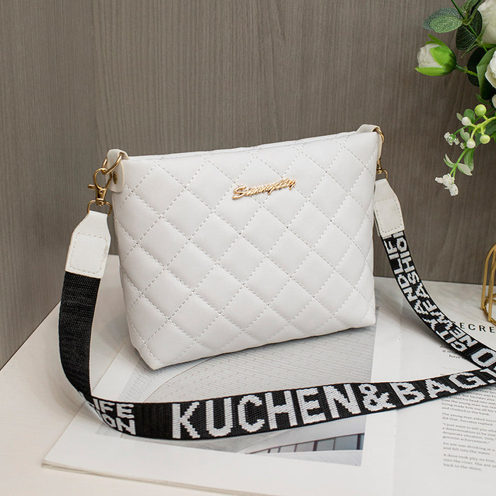 Women's small crossbody bag shown with its quilted pattern, shoulder strap and structured bucket-style silhouette.