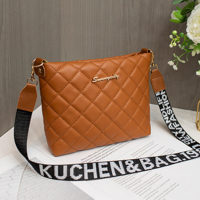 Women's quilted crossbody purse product view showing the exterior pattern, hardware details and compact bag construction.