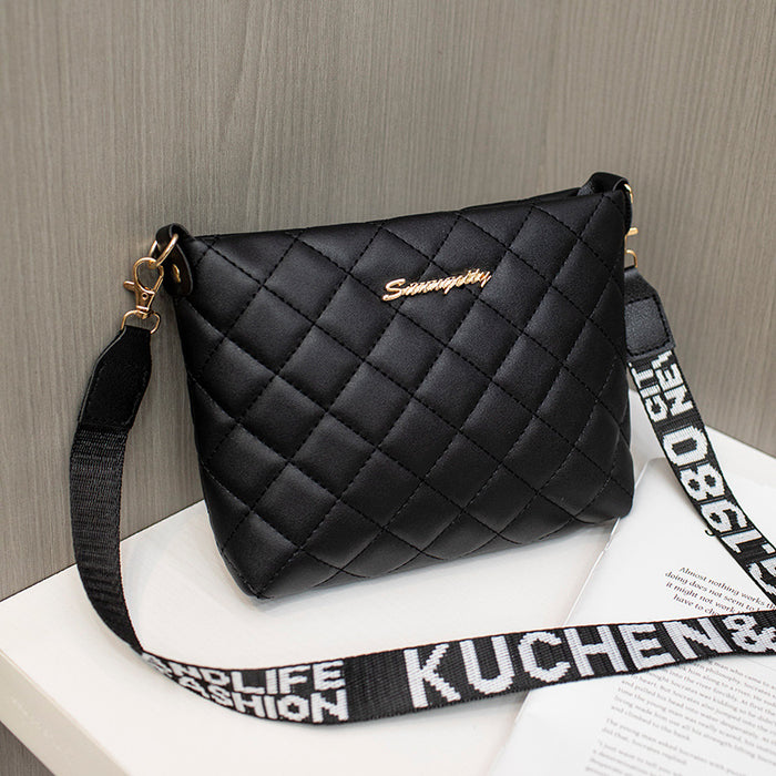 Compact PU handbag for women displayed to show the bucket silhouette, Lingge pattern and chain-accent shoulder design.
