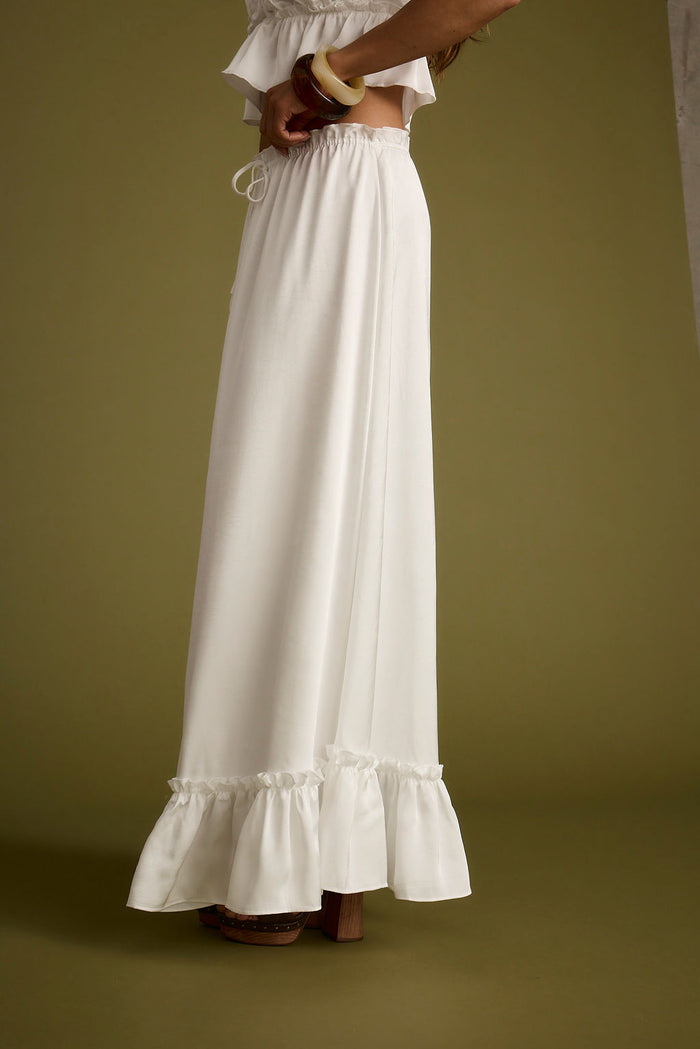 Lifestyle shot of the white maxi skirt styled for day-to-night versatility.