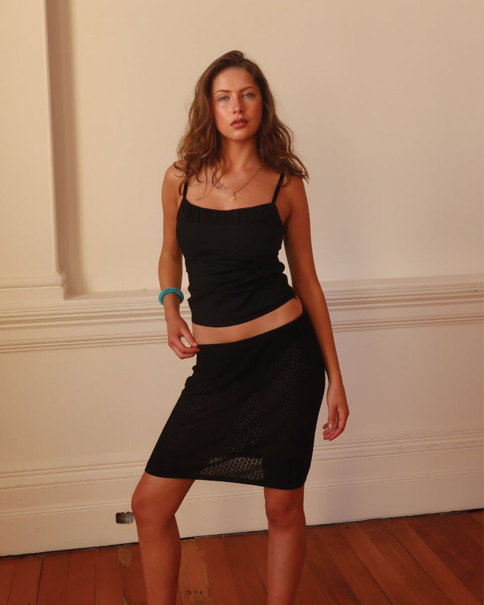Women's summer black singlet with ruched details around the neckline.