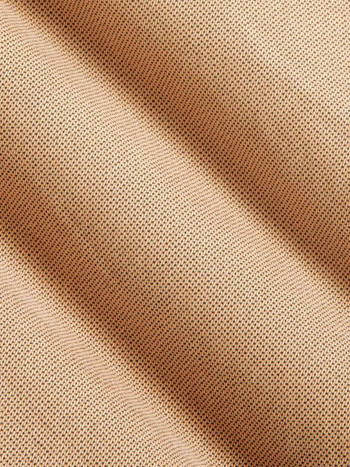 Close-up of beige fabric with subtle texture, ideal for clothing. – Wam Denim.