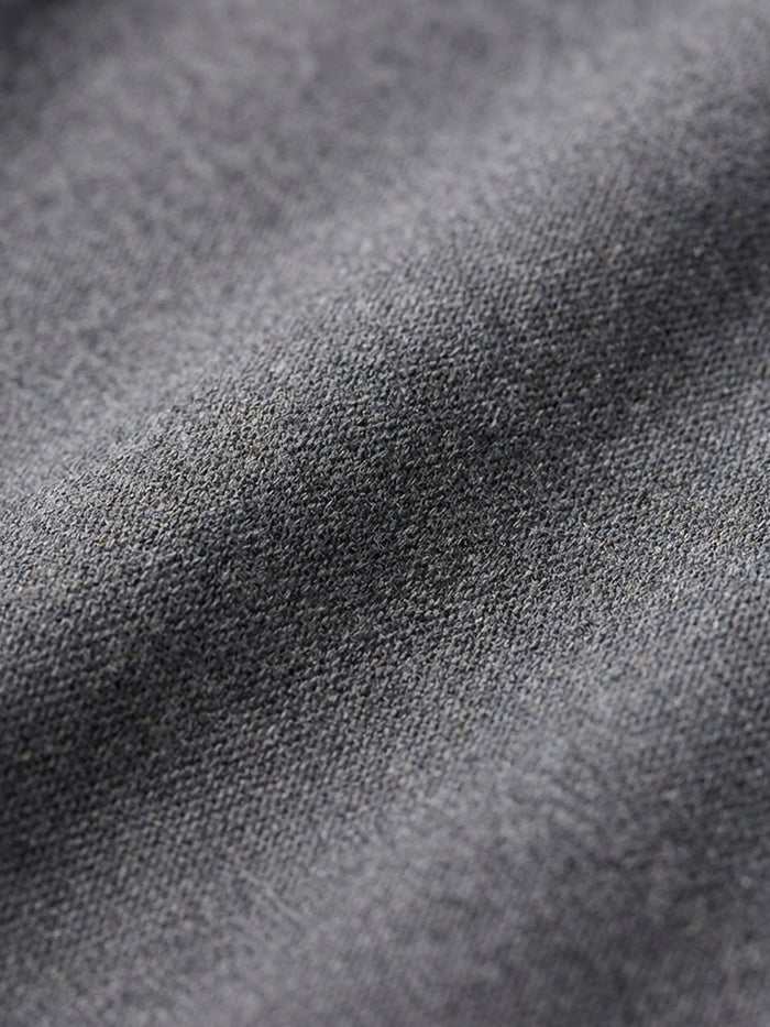 Close-up of grey pantalon fabric texture highlighting soft, durable material detail.