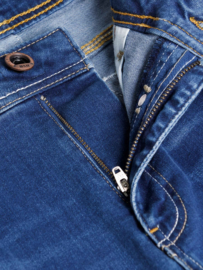 Close-up of light blue jeans zipper and button with contrast stitching detail – Wam Denim.