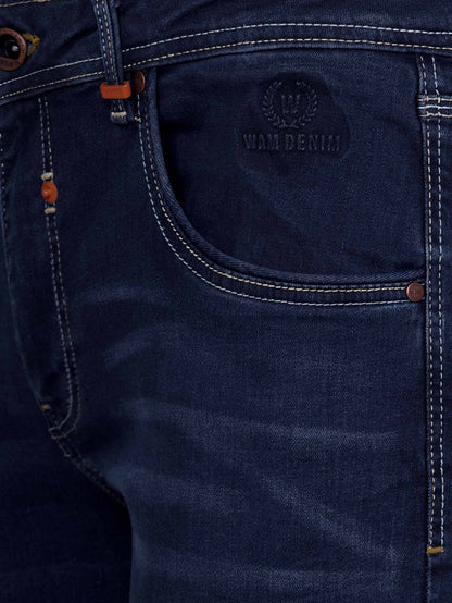 Close-up of dark navy denim jeans front pocket with embossed Wam Denim logo and stitching – Wam Denim.