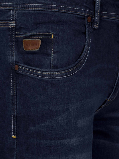 Front pocket close-up of dark navy jeans with leather Wam Denim label and contrast stitching – Wam Denim.