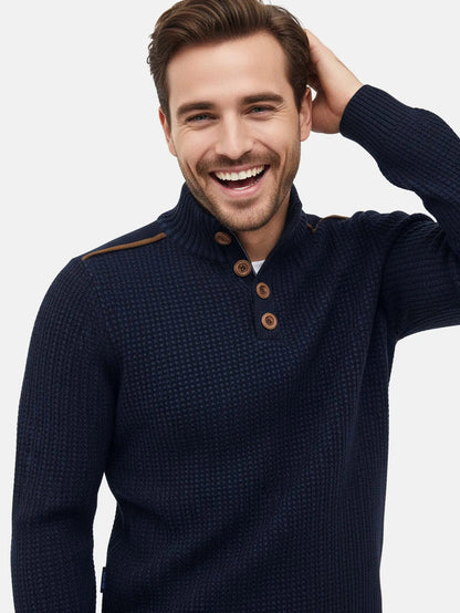 Close-up view of a man wearing an indigo navy textured knit sweater with brown buttons.