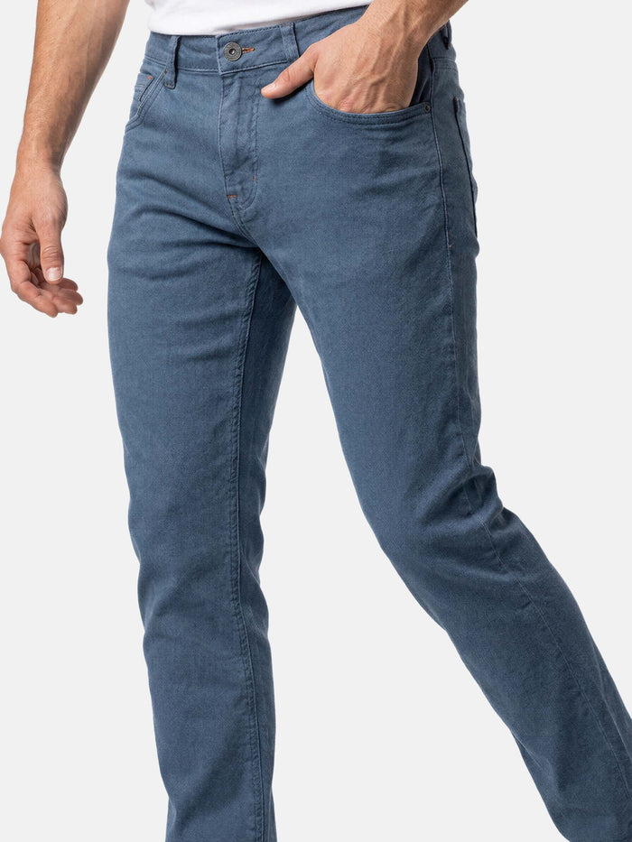 Close-up of slim fit blue men’s stretch denim jeans.