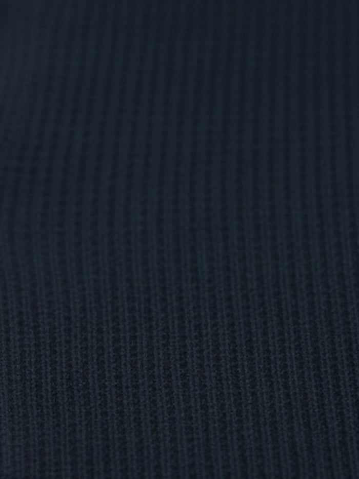 Close-up of navy textured knit fabric from the Zest Navy sweater.