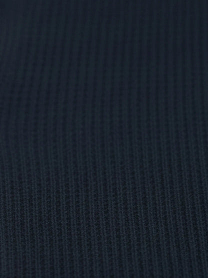 Close-up of navy textured knit fabric from the Zest Navy sweater.