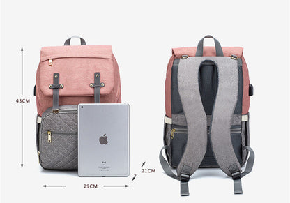 Multifunction mummy bag with compartments for diapers, bottles, clothing and personal items during family outings and travel.