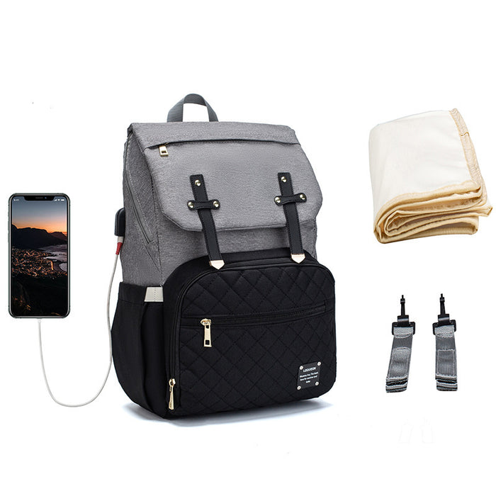 Lequeen diaper bag with roomy storage, multiple pockets and magnetic closure for organizing baby supplies and personal items.