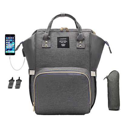 A large capacity mummy bag for diapers, bottles, spare clothing and personal belongings during family trip and daily errands.