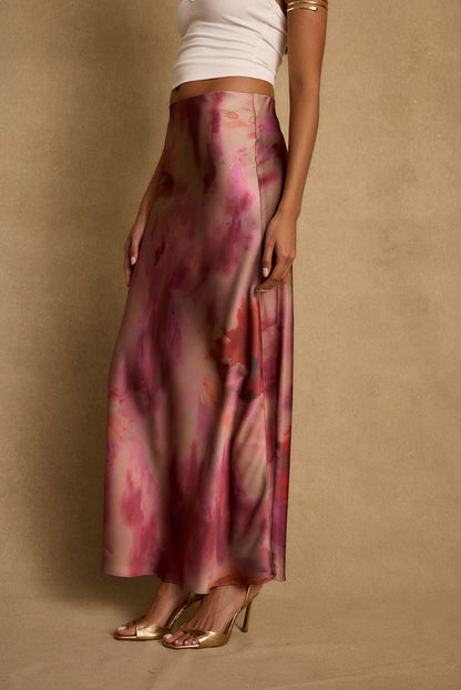 Berry watercolor satin maxi skirt worn with white tank and gold heels.