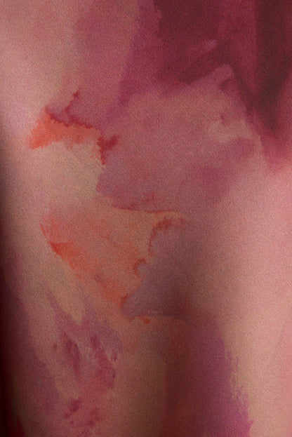 Close-up of berry blur watercolor print on satin maxi skirt fabric, pink and plum tones.