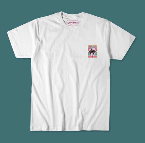 Waihana Electric Palms Premium Pima T-Shirt in White Sand, displayed flat against a teal background, featuring a small retro pink and teal palm tree graphic on the left chest.