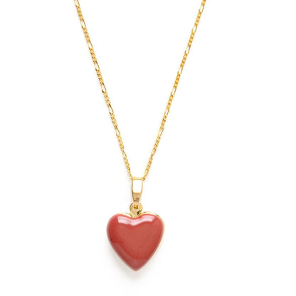 A red heart-shaped locket on a gold-colored chain.