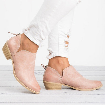 Stylish women’s ankle boots paired with trousers, blazer, and smart casual layers