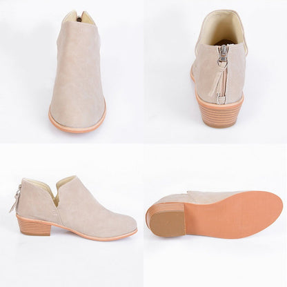 Beige ankle boots with brown soles on a white background