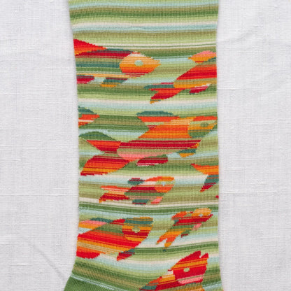 Close-up of the colorful woven fabric with abstract fish pattern on a white background