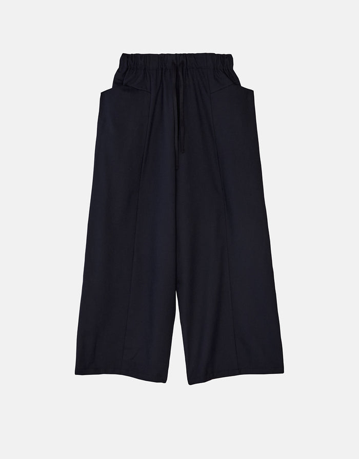 Navy wide-leg pants with a relaxed boyfriend fit, featuring an elastic waistband and large front pockets, crafted from wrinkle-resistant fabric for timeless minimalist style.