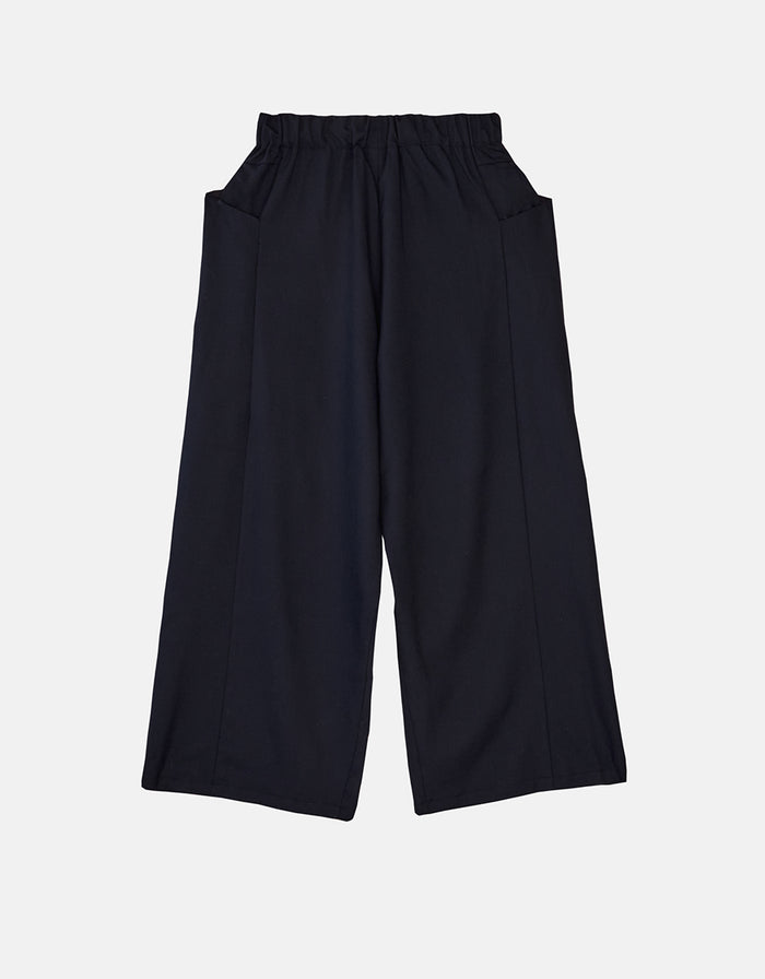 Navy blue boyfriend fit flared pants with an elastic waistband, designed for comfort and wrinkle resistance, exemplifying minimalist and timeless style.