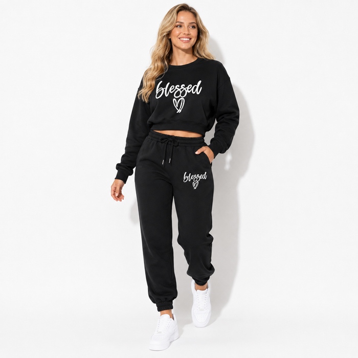 Black fleece two-piece jogger set in a natural walking pose