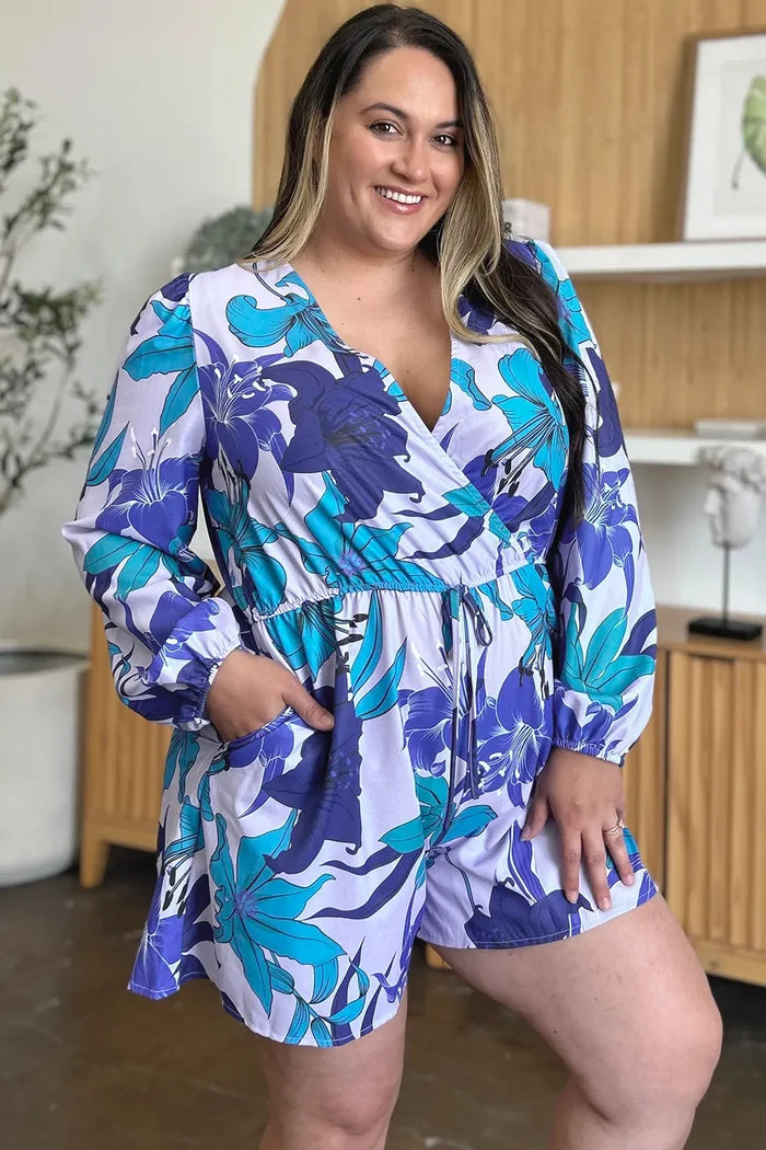 Floral romper in the Blue option showing long sleeves, pockets, 100% polyester and an opaque finish for a coordinated outfit.