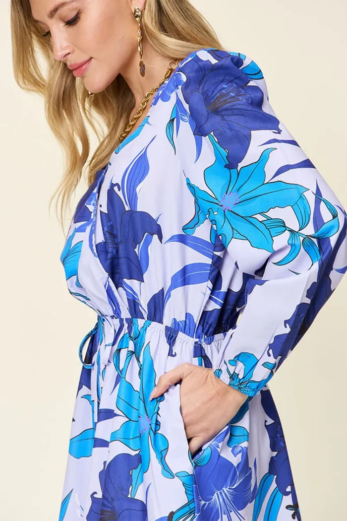 Women's Blue romper with long sleeves, floral pattern, and practical pockets, available in the size range from S through 3XL.