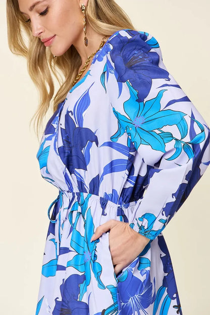 Women's Blue romper with long sleeves, floral pattern, and practical pockets, available in the size range from S through 3XL.