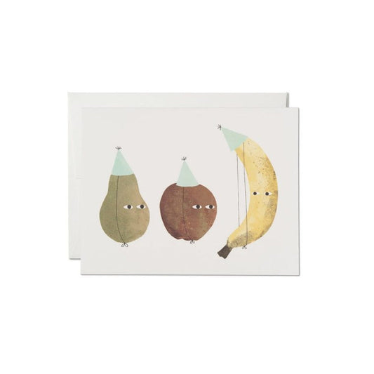 Greeting card with an illustration of three stylized fruits - an apple, a banana, and a pear, each with a party hat on, set against a soft white background.
