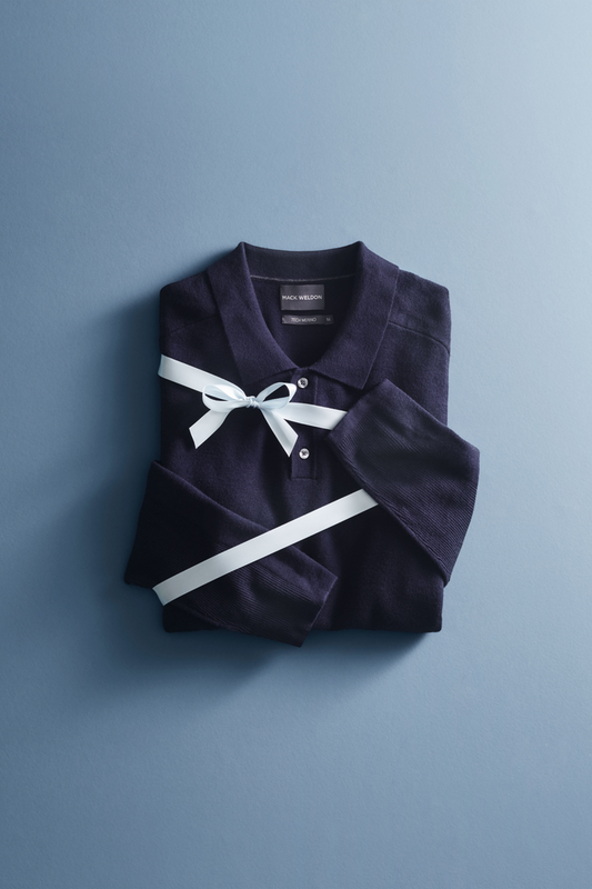 Flat lay view of Blue Sweater tied in a ribbon