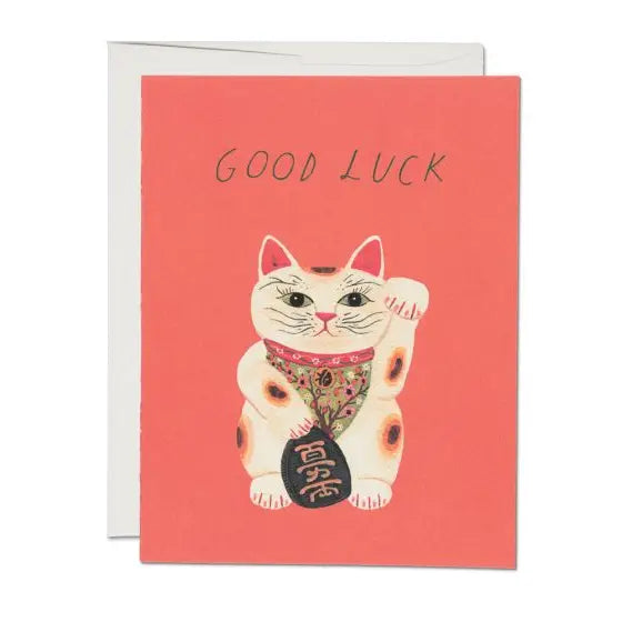 A greeting card with a illustration of a lucky cat with a good luck message, made in the USA.