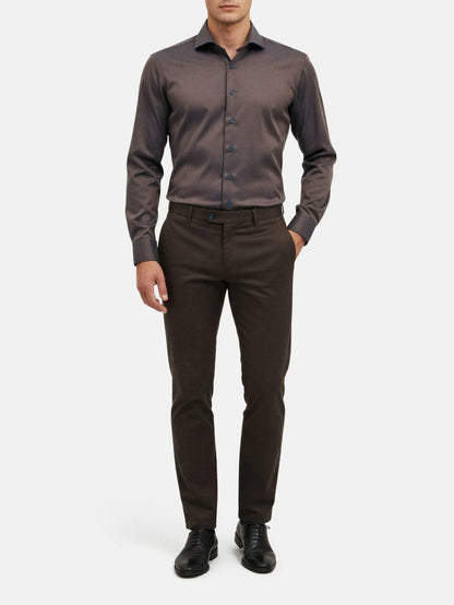 Men wearing light brown slim-fit shirt styled with dark trousers and dress shoes.