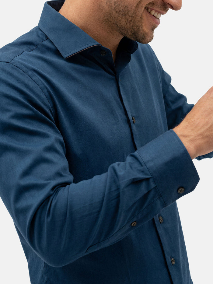 Close-up of petrol blue men’s shirt showing collar, buttons, and smooth premium fabric.